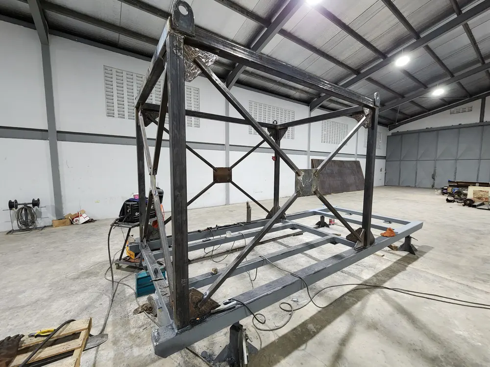 Welded steel structural frame with cross bracing and lifting lugs under fabrication at Q² Machines