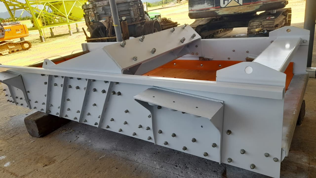 Grey fabricated screen box with an orange wear liner